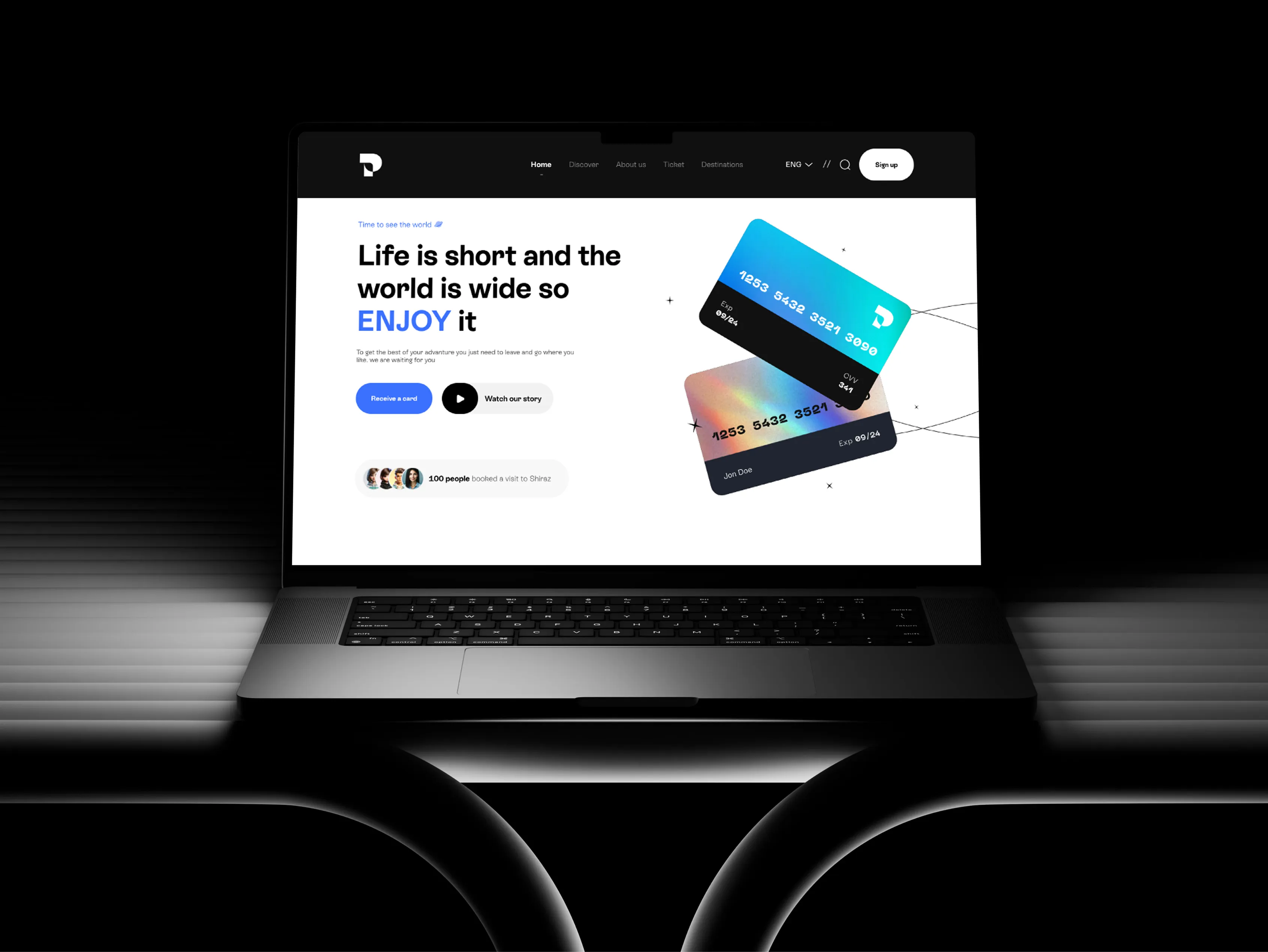 Travel platform homepage with payment-card visuals displayed on a laptop